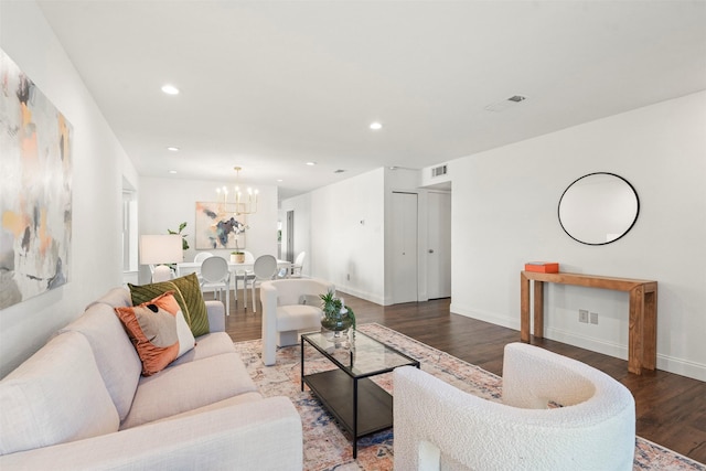 living room featuring hardwood / wood-style flooring and an inviting chandelier