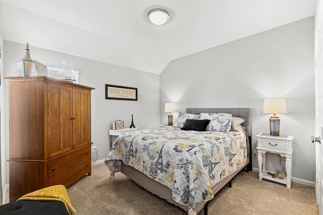 bedroom with light colored carpet and lofted ceiling