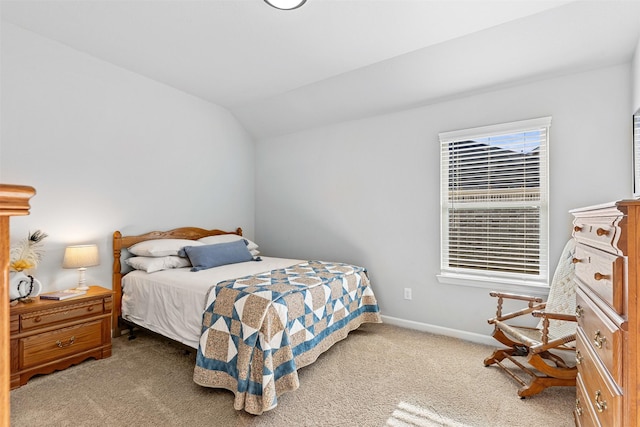 carpeted bedroom with lofted ceiling