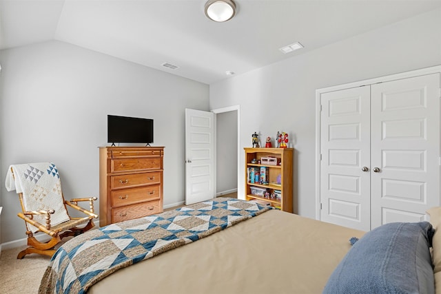 bedroom featuring carpet, vaulted ceiling, and a closet