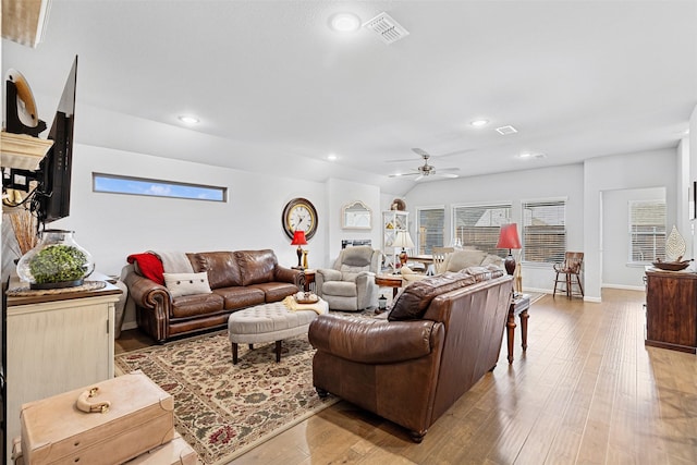 living room featuring light hardwood / wood-style floors, ceiling fan, and lofted ceiling