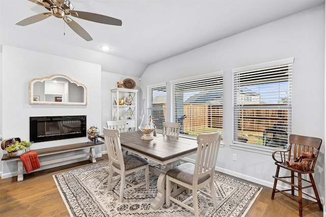 dining room featuring a wealth of natural light, hardwood / wood-style floors, ceiling fan, and lofted ceiling