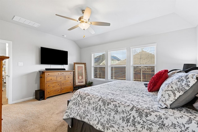 carpeted bedroom with ceiling fan and vaulted ceiling