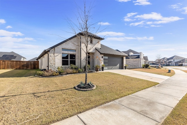 view of front of property featuring a front lawn and a garage