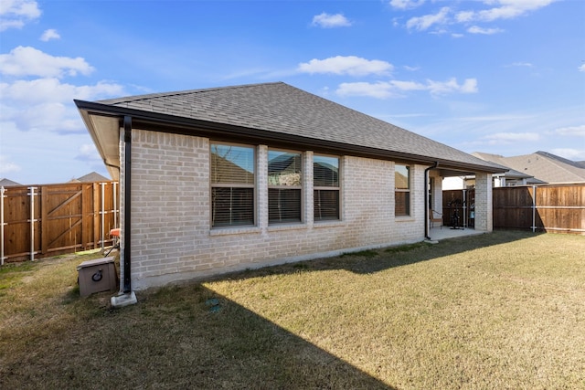 rear view of property with a lawn