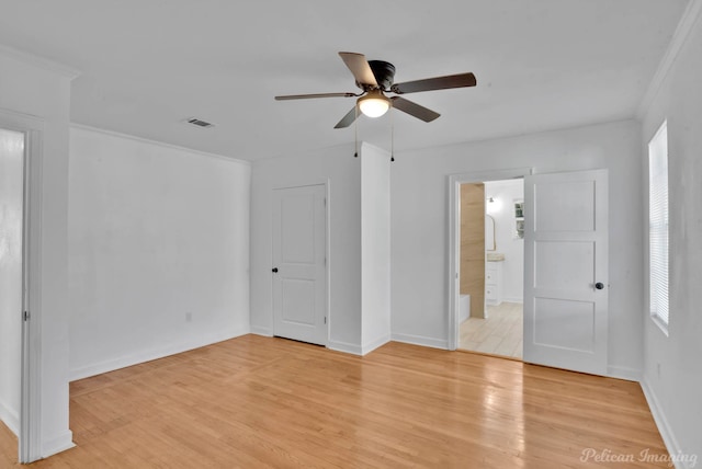 empty room featuring crown molding, ceiling fan, and light hardwood / wood-style floors