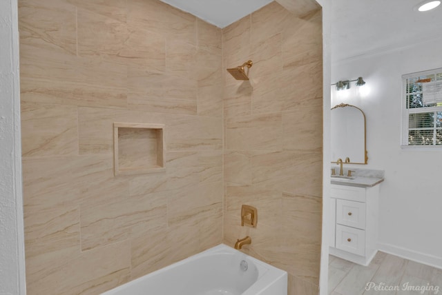 bathroom featuring vanity and tiled shower / bath combo