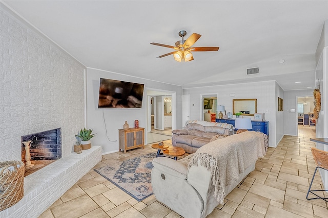 living room with a fireplace, ceiling fan, and lofted ceiling