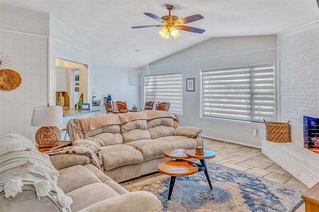 tiled living room with ceiling fan and lofted ceiling