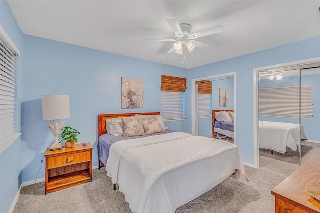 bedroom featuring ceiling fan and light carpet