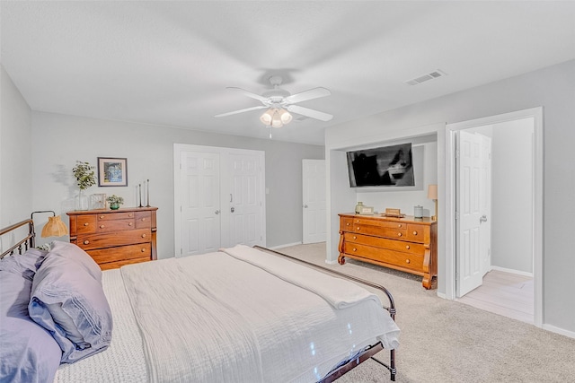 carpeted bedroom with a closet and ceiling fan