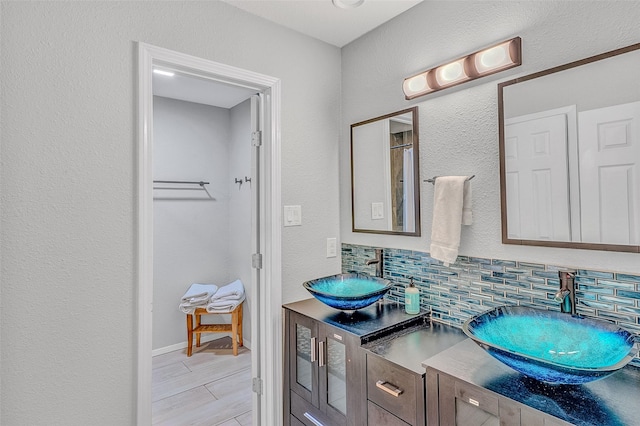 bathroom with vanity and decorative backsplash