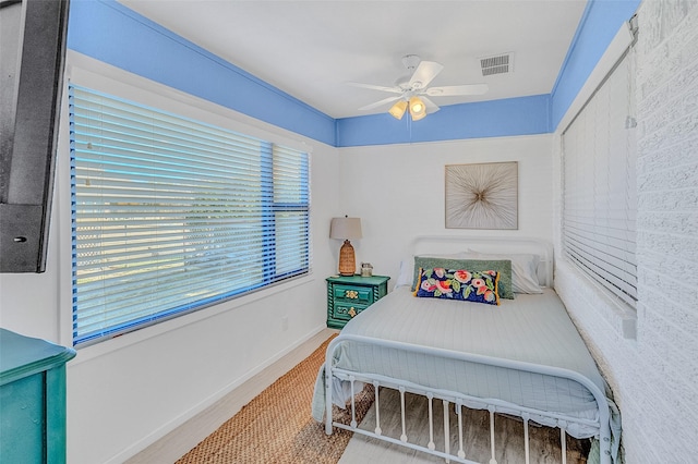 bedroom featuring ceiling fan and multiple windows