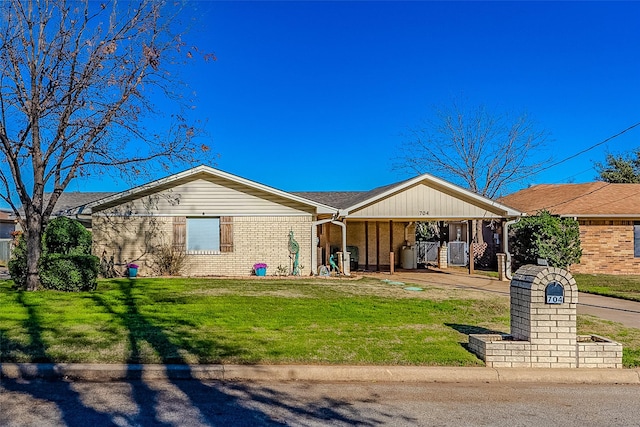 single story home with a front yard and a carport