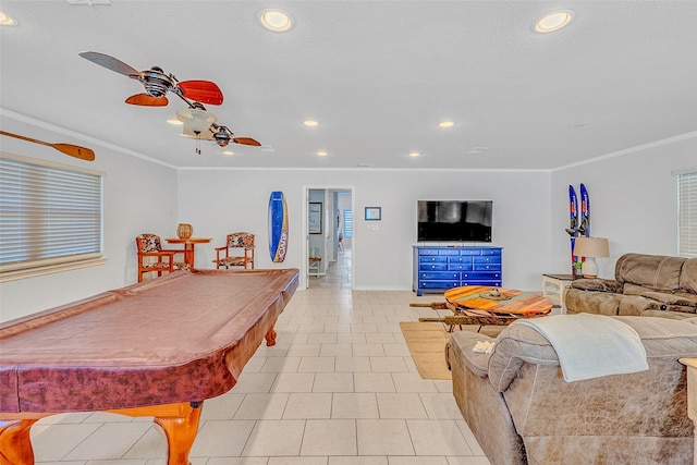 rec room with light tile patterned floors, crown molding, and ceiling fan