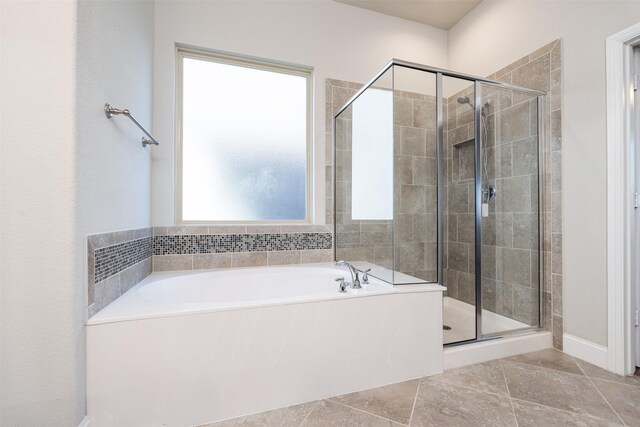 full bathroom with a stall shower, tile patterned flooring, and a garden tub