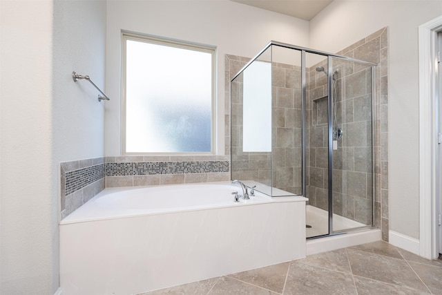 bathroom with separate shower and tub and tile patterned floors