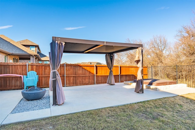 view of patio with an outdoor fire pit and fence