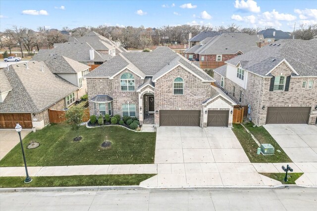 front facade featuring a front yard and a garage