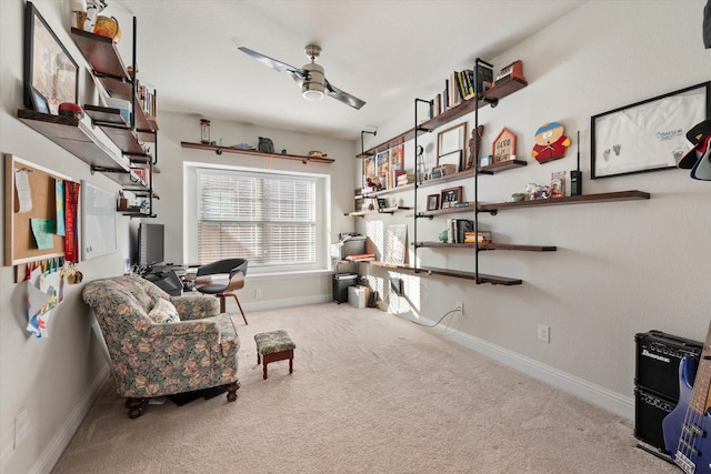 living area with light carpet and ceiling fan