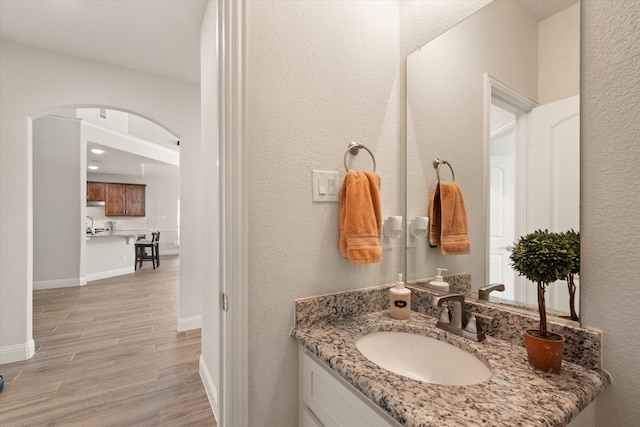 bathroom with vanity and wood-type flooring