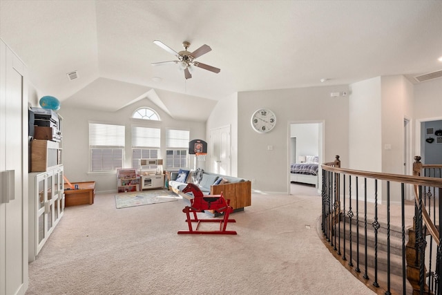 carpeted living room with ceiling fan and lofted ceiling