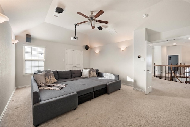 home theater with vaulted ceiling, light colored carpet, and ceiling fan