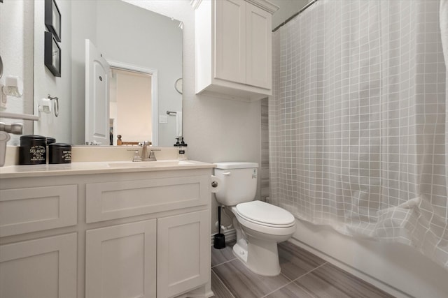 full bathroom featuring vanity, shower / bath combo with shower curtain, and toilet