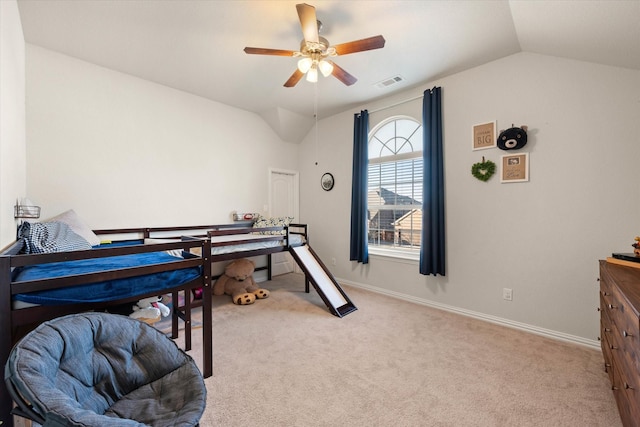 bedroom featuring vaulted ceiling, light carpet, and ceiling fan