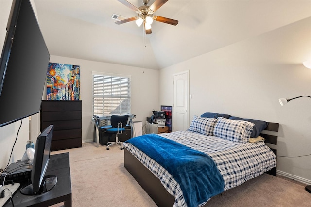 carpeted bedroom with ceiling fan and vaulted ceiling