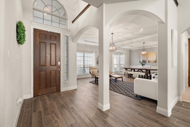 foyer entrance with a notable chandelier