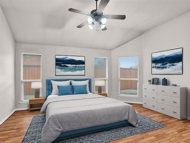 bedroom with light wood-type flooring, ceiling fan, lofted ceiling, and multiple windows