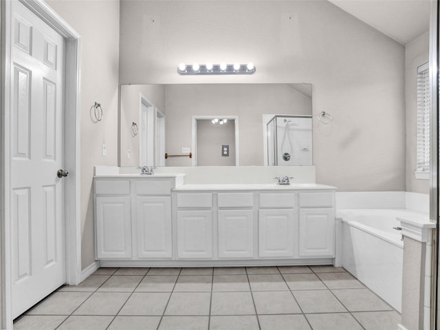 bathroom with vanity, tile patterned flooring, and plus walk in shower