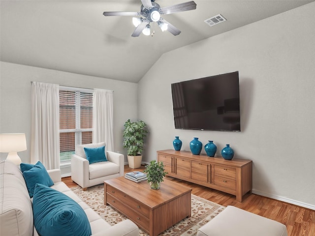 living room featuring vaulted ceiling, ceiling fan, and light hardwood / wood-style flooring