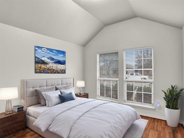 bedroom featuring vaulted ceiling and hardwood / wood-style floors