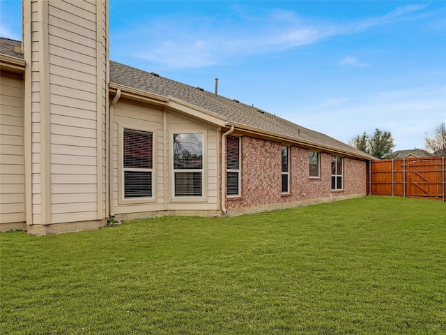 rear view of house featuring a yard