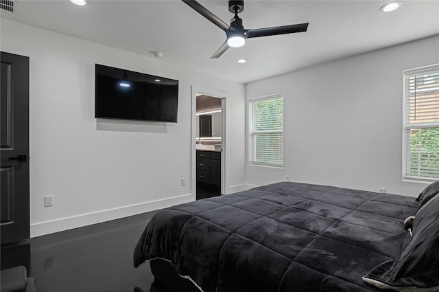 bedroom featuring multiple windows, connected bathroom, and ceiling fan