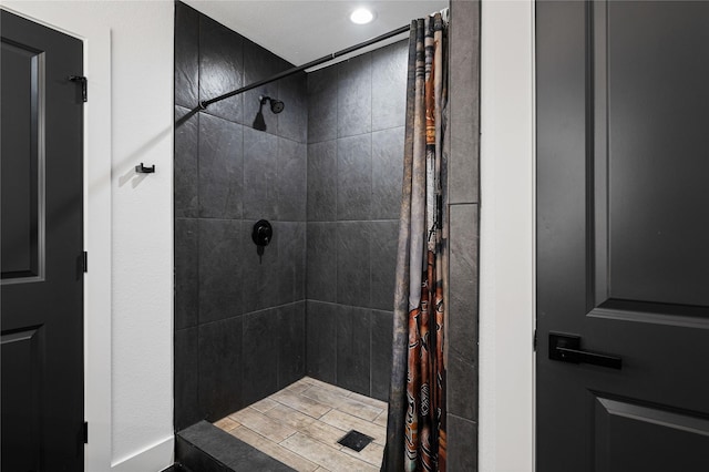 bathroom with tiled shower