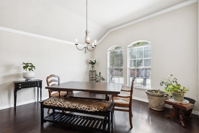 dining area with dark wood-type flooring, lofted ceiling, crown molding, and an inviting chandelier