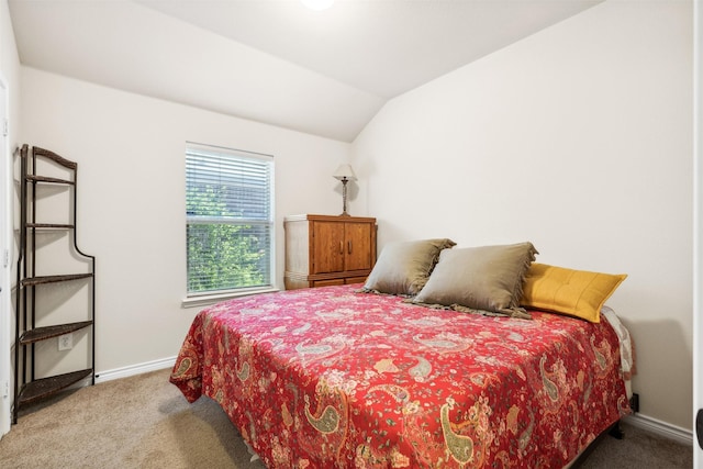 bedroom with carpet flooring and lofted ceiling