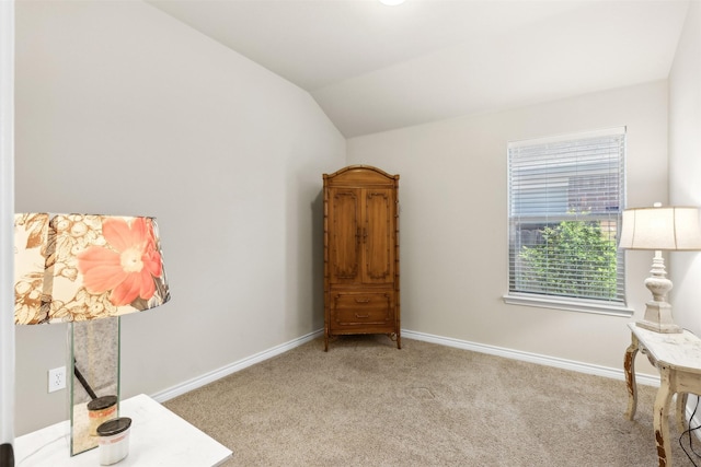 living area featuring lofted ceiling and light carpet