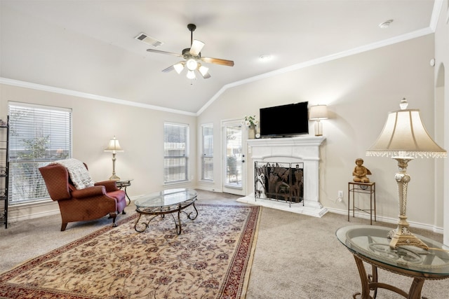 living room featuring a healthy amount of sunlight, light colored carpet, vaulted ceiling, and crown molding