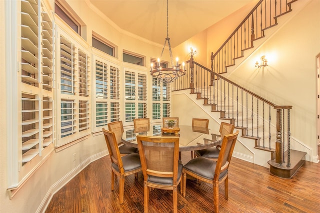 dining room with an inviting chandelier, crown molding, and wood-type flooring