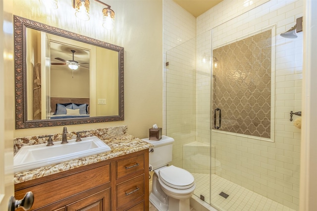 bathroom featuring an enclosed shower, vanity, toilet, and ceiling fan