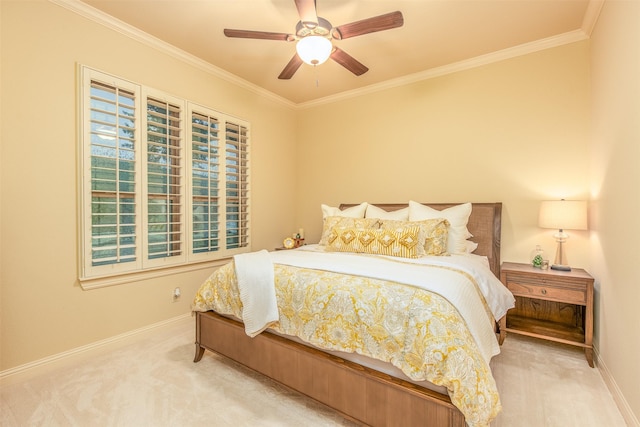 bedroom featuring ornamental molding, light colored carpet, and ceiling fan