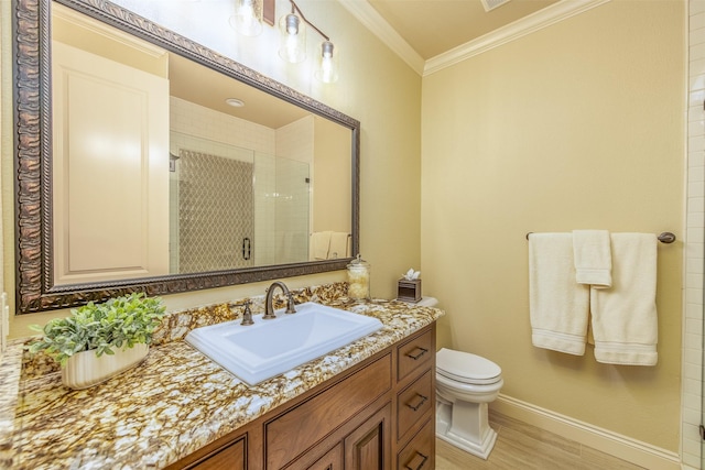 bathroom featuring wood-type flooring, ornamental molding, vanity, toilet, and a shower with door