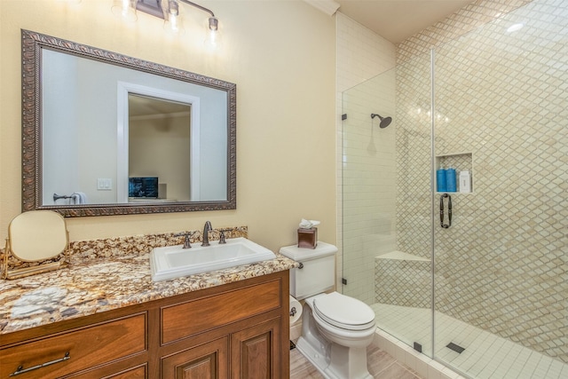 bathroom featuring vanity, an enclosed shower, and toilet