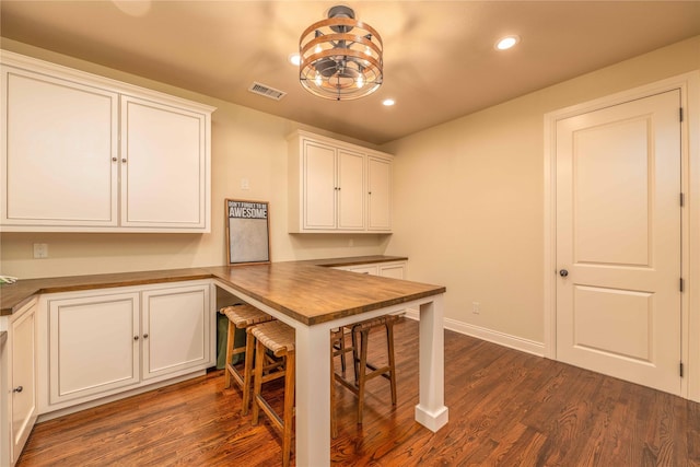 dining area with built in desk and dark hardwood / wood-style flooring