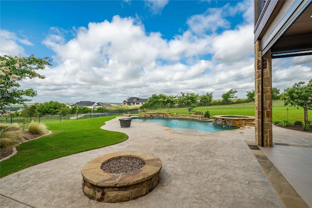 view of pool featuring a yard, a fire pit, a patio, and an in ground hot tub