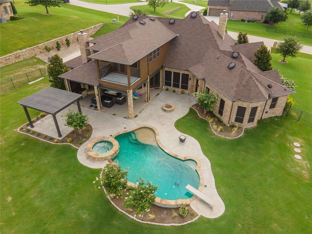 view of pool with an in ground hot tub, a diving board, a lawn, and a patio area